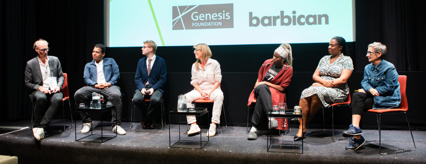 Will Gompertz, Jamie Njoku-Goodwin, Jack Gamble, Pip Jamieson, Shannie Mears, and Audrey Solvar at NETWORKS, live at the Barbican. The panelists are sat in a row with a large white screen behind them. On the screen is the text 'Genesis Conversations', and below that is the genesis foundation logo and the barbican logo.1