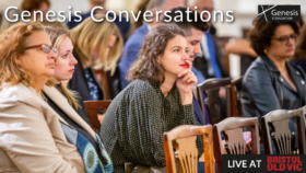 Amongst a seated audience, a close up of a person sat on a wooden chair, leaning forwards and holding one hand to their face, concentrating on the panel talk happening off camera. They have shoulder length wavy brown hair, and are wearing a green checked shirt and red lipstick. In the top corner is the text ‘Genesis Conversations’. In bottom right is the text ‘Live at Bristol Old Vic’.