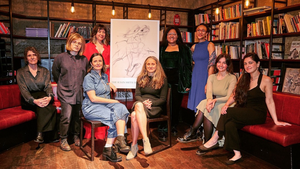 The finalists for the 2024 Susan Smith Blackburn Prize stood and sat in front of a colourful bookcase, smiling at the camera.