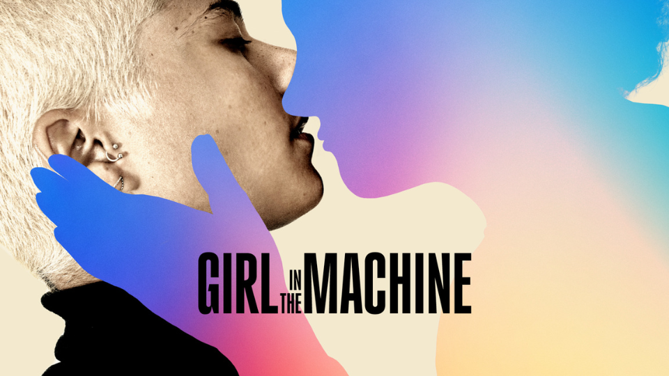 A person with short buzzed blonde hair tilting their head upwards to kiss a purple, blue and yellow silhouette of another person. The silhouette holds the blonde person's with one hand. In the centre of the image is black text saying 'Girl in the Machine'.